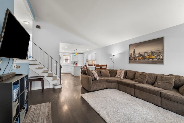 living area featuring dark wood-type flooring, recessed lighting, lofted ceiling, and stairway