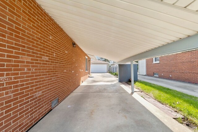 view of patio with an outbuilding and a carport