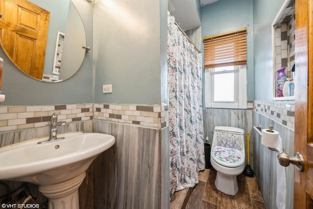 3610 Lombard Ave, Berwyn, IL 60402 - bathroom featuring tile walls, a wainscoted wall, toilet, a sink, and curtained shower