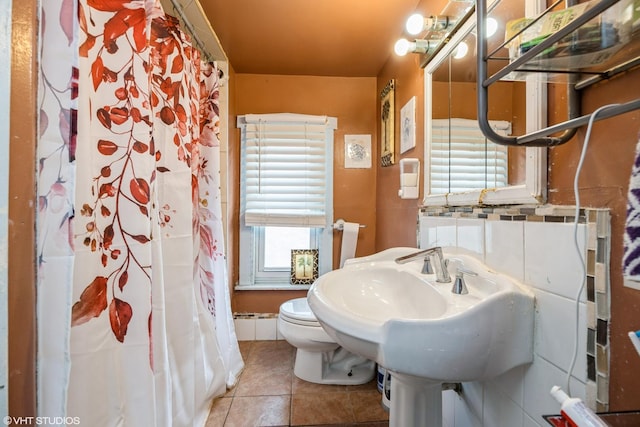 3610 Lombard Ave, Berwyn, IL 60402 - full bathroom featuring tile patterned flooring, toilet, curtained shower, and a sink