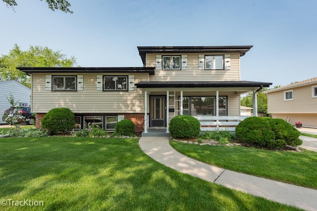 838 S Michigan Ave, Addison, IL 60101 - split level home with a front lawn, covered porch, and brick siding