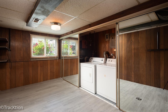 838 S Michigan Ave, Addison, IL 60101 - laundry area featuring washer and dryer, wood walls, and light wood-style floors