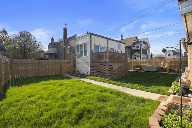 view of yard with a deck and a fenced backyard