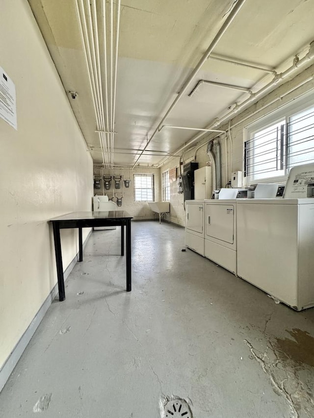 below grade area with baseboards and washing machine and clothes dryer