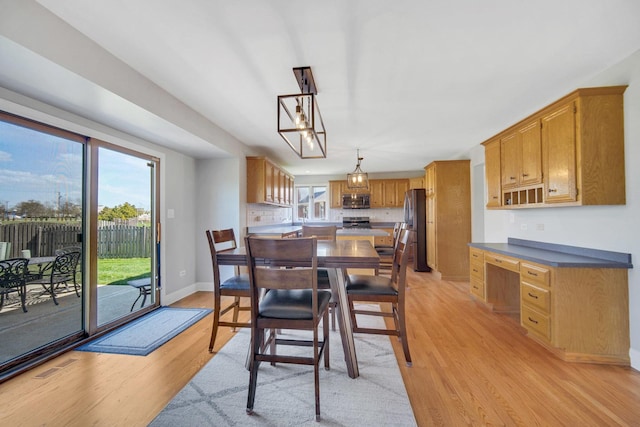 1075 Grand Mesa Ave, New Lenox, IL 60451 - dining room with baseboards, visible vents, and light wood finished floors