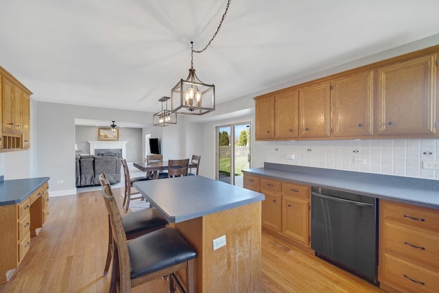1075 Grand Mesa Ave, New Lenox, IL 60451 - kitchen with decorative backsplash, a kitchen island, dark countertops, dishwashing machine, and light wood-style flooring