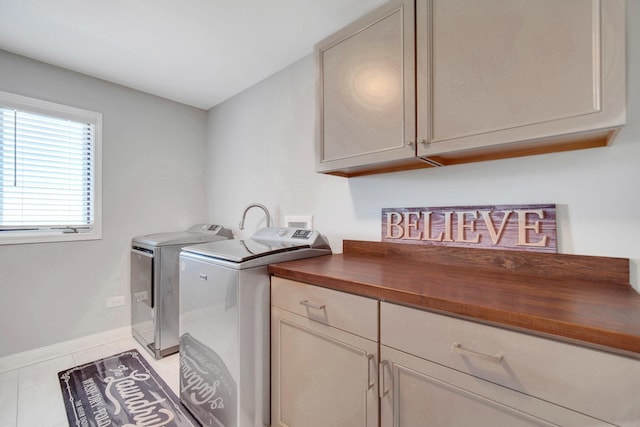 1075 Grand Mesa Ave, New Lenox, IL 60451 - clothes washing area featuring baseboards, cabinet space, light tile patterned flooring, and independent washer and dryer