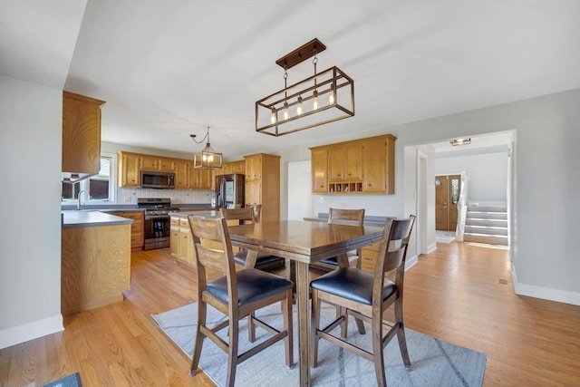 1075 Grand Mesa Ave, New Lenox, IL 60451 - dining room with baseboards, stairs, and light wood-style flooring