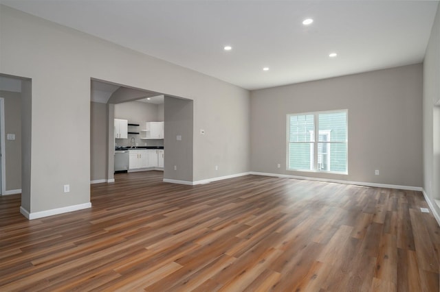 510 E Washington St, Pontiac, IL 61764 - unfurnished living room featuring recessed lighting, a sink, baseboards, and dark wood finished floors