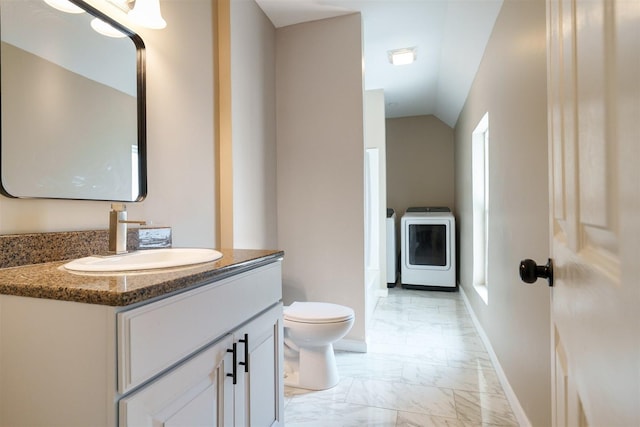 510 E Washington St, Pontiac, IL 61764 - bathroom featuring vaulted ceiling, marble finish floor, washer / dryer, toilet, and vanity