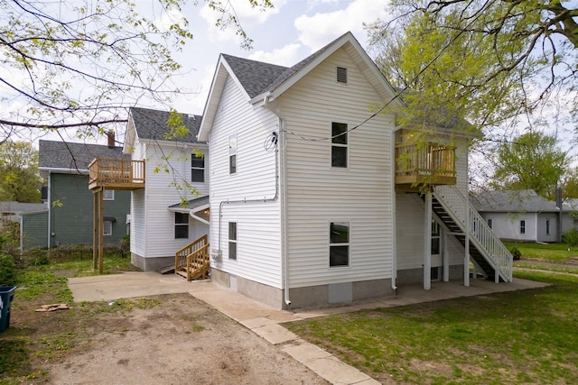 510 E Washington St, Pontiac, IL 61764 - back of house with roof with shingles, a balcony, and stairs
