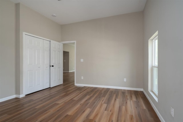 510 E Washington St, Pontiac, IL 61764 - unfurnished bedroom featuring baseboards, wood finished floors, and a closet