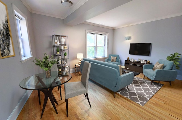 living area featuring crown molding, baseboards, wood finished floors, and plenty of natural light