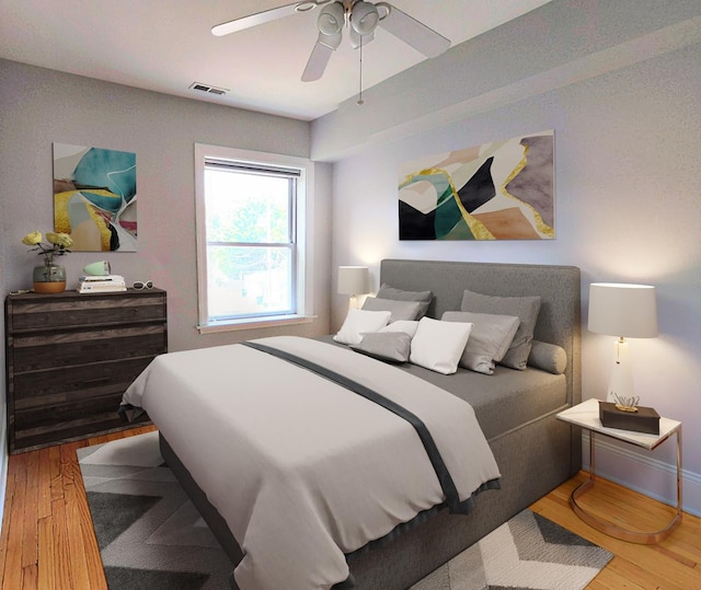bedroom with wood finished floors, visible vents, and ceiling fan