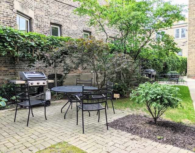 view of patio with area for grilling and outdoor dining area