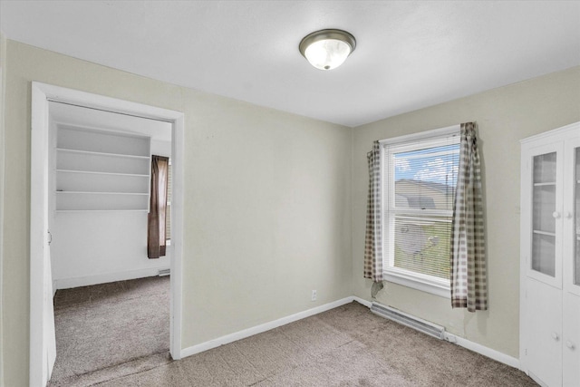 carpeted empty room with baseboards