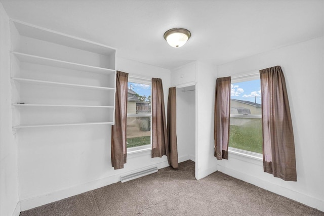 carpeted empty room with visible vents and baseboards