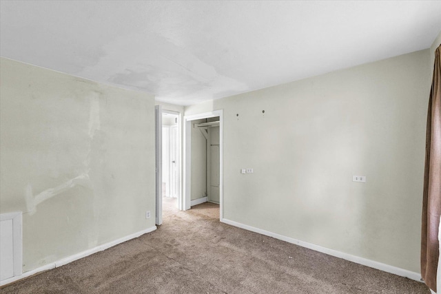 carpeted spare room with baseboards