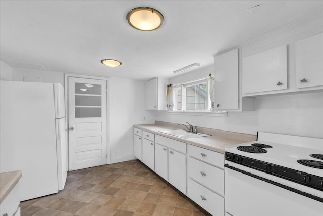 kitchen with white cabinets, light countertops, a sink, and white appliances