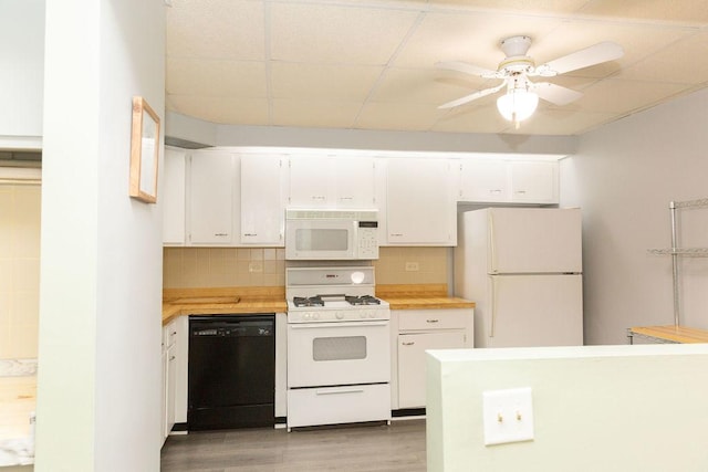 kitchen with white cabinetry, light wood-style floors, white appliances, a ceiling fan, and backsplash