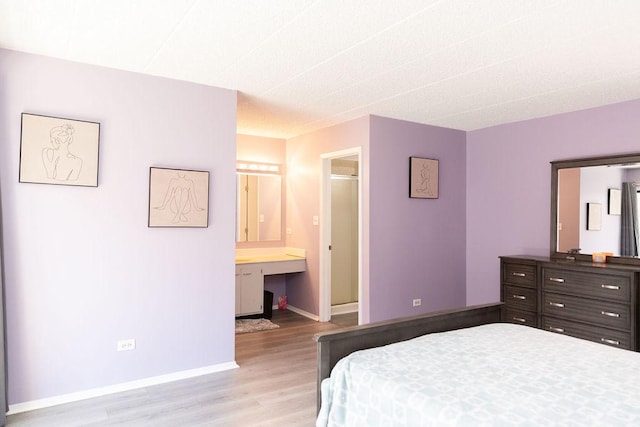 bedroom with light wood-style floors and baseboards