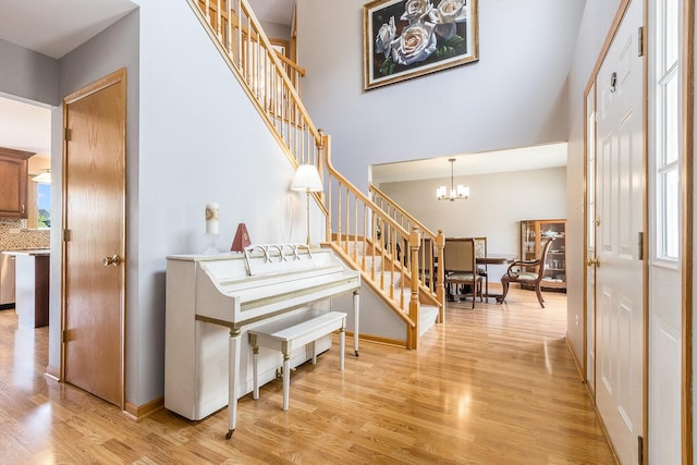 1518 Parkside Dr, Plainfield, IL 60586 - foyer featuring an inviting chandelier, light wood-style floors, stairway, and a towering ceiling
