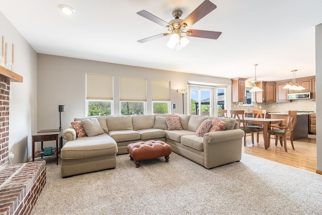 1518 Parkside Dr, Plainfield, IL 60586 - living room with light carpet, a brick fireplace, and a ceiling fan