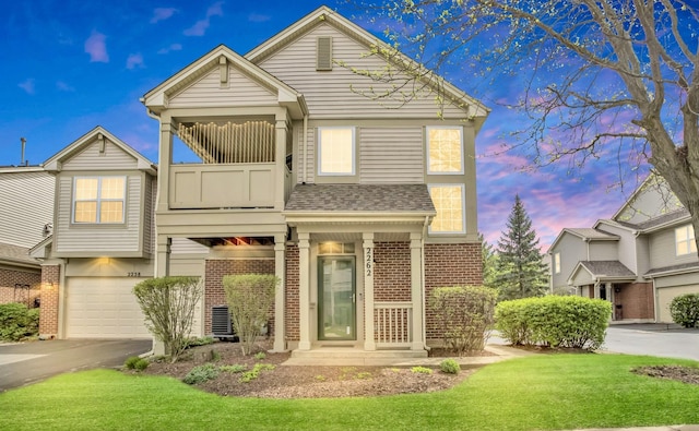 2262 Rockefeller Dr, Geneva, IL 60134 - view of front of house with brick siding, a garage, a balcony, and a front yard