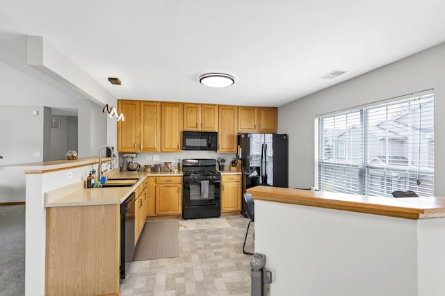 2262 Rockefeller Dr, Geneva, IL 60134 - kitchen featuring visible vents, a sink, light countertops, black appliances, and a peninsula