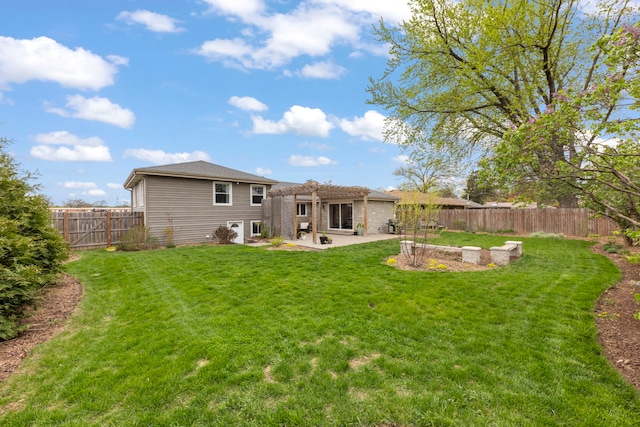 back of house featuring a lawn, a pergola, a fenced backyard, and a patio area