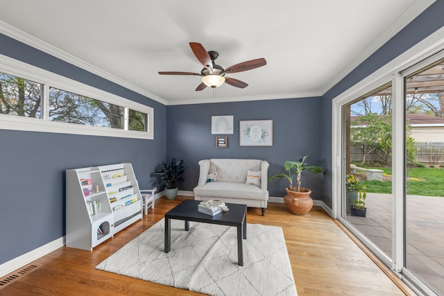 sitting room featuring crown molding, baseboards, and ceiling fan