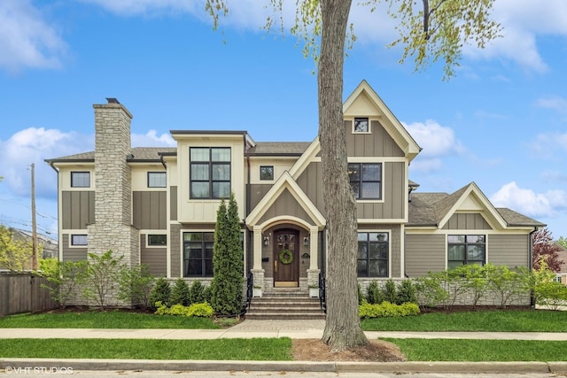 236 W Crescent Ave, Elmhurst, IL 60126 - view of front facade featuring board and batten siding, a chimney, and roof with shingles