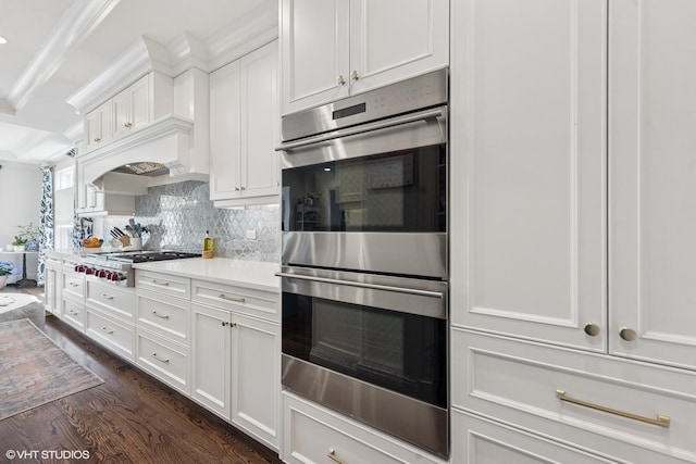 236 W Crescent Ave, Elmhurst, IL 60126 - kitchen featuring stainless steel appliances, decorative backsplash, light countertops, dark wood-type flooring, and white cabinets