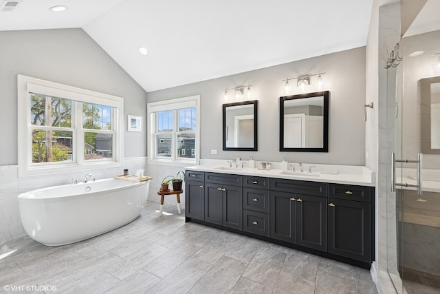 236 W Crescent Ave, Elmhurst, IL 60126 - bathroom featuring double vanity, a stall shower, a freestanding bath, lofted ceiling, and a wainscoted wall