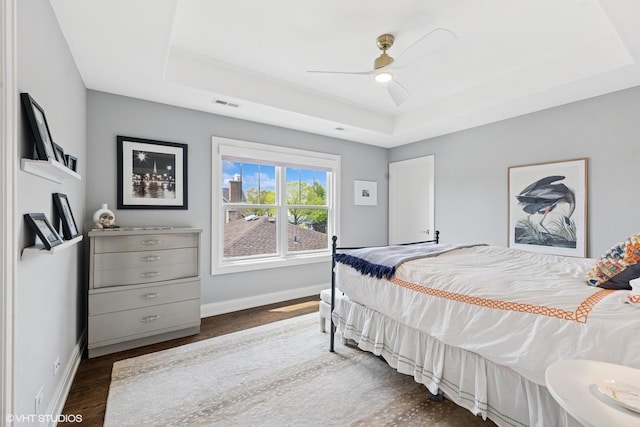 236 W Crescent Ave, Elmhurst, IL 60126 - bedroom with a tray ceiling, baseboards, dark wood-style flooring, and a ceiling fan