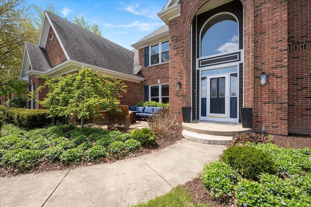 6N372 E Ridgewood Dr, Saint Charles, IL 60175 - view of exterior entry featuring outdoor lounge area, brick siding, and roof with shingles