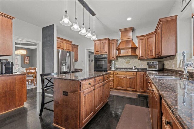 6N372 E Ridgewood Dr, Saint Charles, IL 60175 - kitchen with premium range hood, a sink, brown cabinetry, backsplash, and a center island