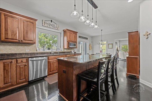 6N372 E Ridgewood Dr, Saint Charles, IL 60175 - kitchen featuring appliances with stainless steel finishes, a sink, healthy amount of natural light, and a center island