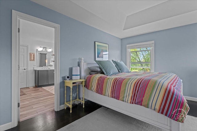 6N372 E Ridgewood Dr, Saint Charles, IL 60175 - bedroom featuring wood finished floors, a raised ceiling, baseboards, a sink, and ensuite bath