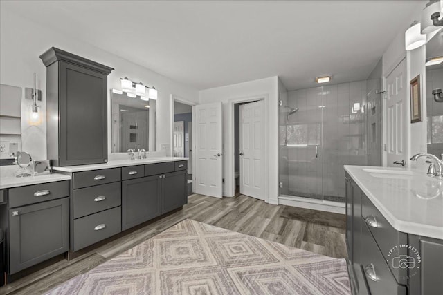 6N372 E Ridgewood Dr, Saint Charles, IL 60175 - bathroom featuring a shower stall, wood finished floors, and two vanities