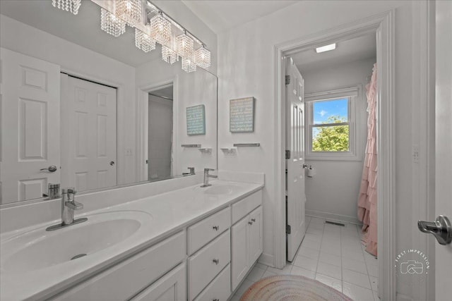 6N372 E Ridgewood Dr, Saint Charles, IL 60175 - bathroom featuring double vanity, tile patterned floors, and baseboards