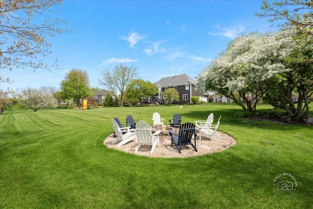 6N372 E Ridgewood Dr, Saint Charles, IL 60175 - view of grassy yard with a playground and an outdoor fire pit