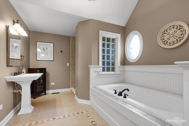 5900G Red Gate Ln, Yorkville, IL 60560 - full bathroom featuring tile patterned floors, a bath, a wainscoted wall, vaulted ceiling, and a shower