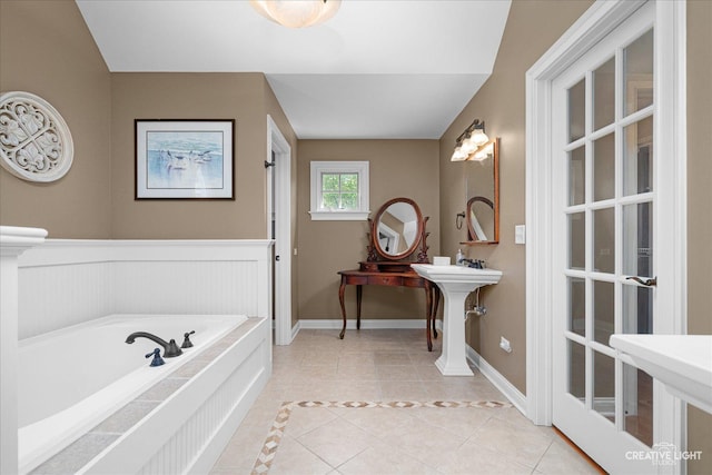 5900G Red Gate Ln, Yorkville, IL 60560 - bathroom featuring tile patterned floors, a bath, a sink, baseboards, and wainscoting