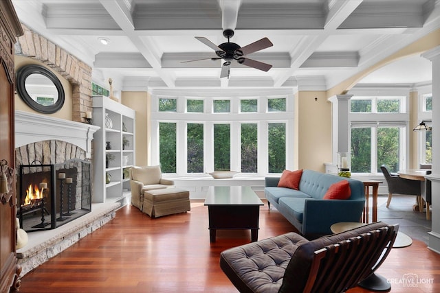 5900G Red Gate Ln, Yorkville, IL 60560 - living room featuring a stone fireplace, beamed ceiling, coffered ceiling, crown molding, and wood finished floors