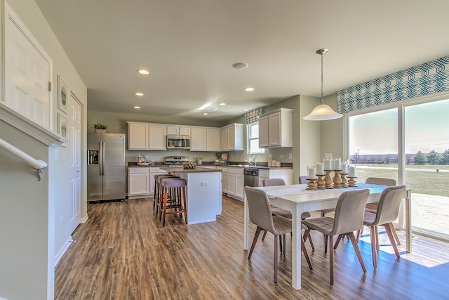 dining area featuring dark wood finished floors, recessed lighting, and baseboards