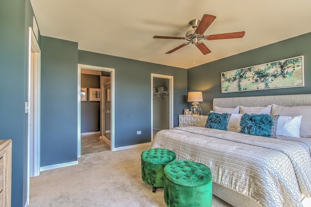 bedroom featuring connected bathroom, a closet, baseboards, carpet floors, and a spacious closet