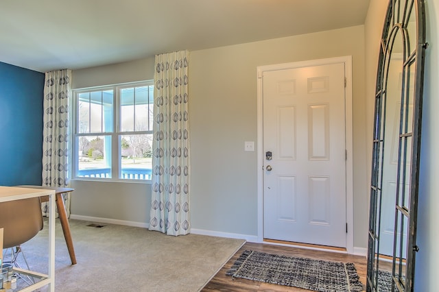 entryway featuring visible vents, wood finished floors, and baseboards
