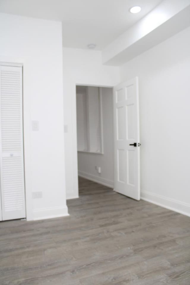unfurnished room featuring baseboards and wood finished floors