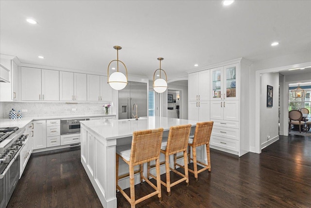 130 Ravine Forest Dr, Lake Bluff, IL 60044 - kitchen featuring recessed lighting, dark wood-type flooring, tasteful backsplash, light countertops, and appliances with stainless steel finishes